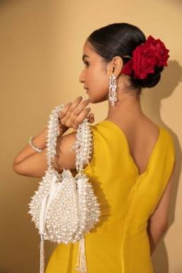 pearl bag vs clutch vs potli - Pearl Bag: Elegant and smooth against delicate wedding fabrics.